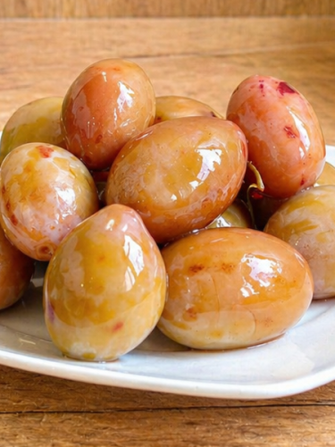 Hungarian plums pickled in vinegar, a sweet and tangy side dish for meats, cheeses, and appetizers.