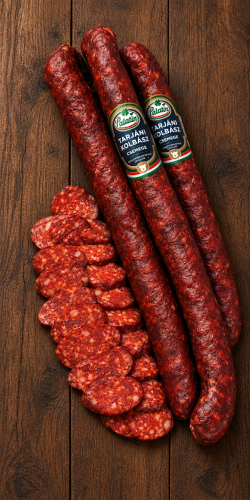 Palatin Tarjáni Csemege mild Hungarian dry-cured and smoked sausage, shown whole and sliced on rustic wood. Discover Hungarian meats at OstryStefek.pl.