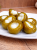 Hot pickled cherry peppers stuffed with garlic in a plastic bucket, traditional Hungarian unpasteurized vegetable pickle.