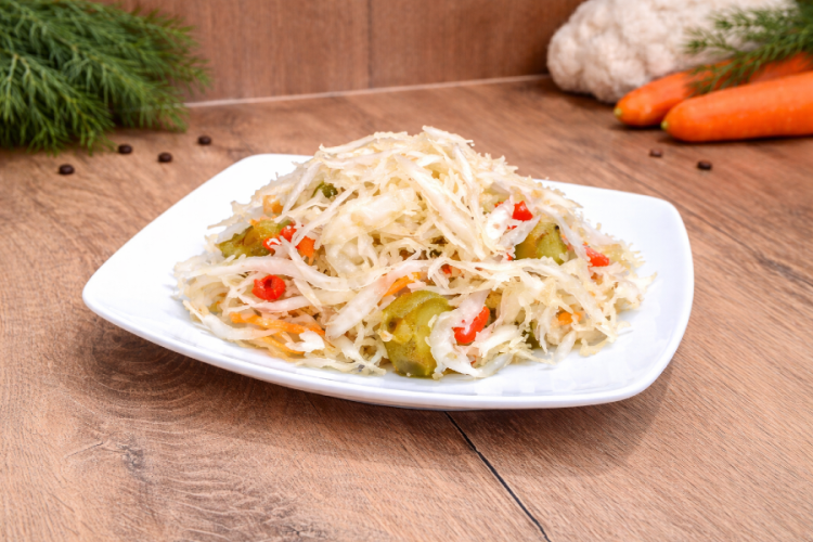 Hot Hungarian pickled vegetable salad (Csalamádé csípős) in a plastic bucket.