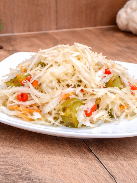 Hot Hungarian pickled vegetable salad (Csalamádé csípős) in a plastic bucket.