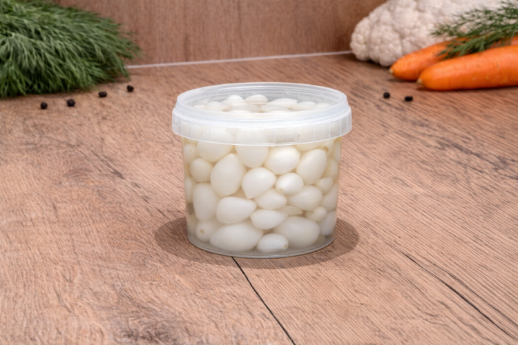 Węgierski czosnek marynowany z Vecsés w plastikowym pojemniku.