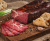 Feketekői dry-cured, air-dried pork neck is Hungarian spiced charcuterie with notes of black pepper and juniper. Firm, richly savory, and elegant—perfect for boards, premium sandwiches, and tasting plates. Vacuum packed.