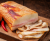Hungarian smoked and dry-aged Mangalica pork fat – traditional artisanal delicacy with a creamy texture and rich natural smoke aroma. Presented on a rustic wooden board, perfect for serving with fresh bread and classic European appetizers.