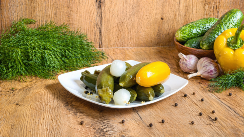 Hungarian mini zucchini pickled in vinegar with onion, mustard, coriander, and spices.
