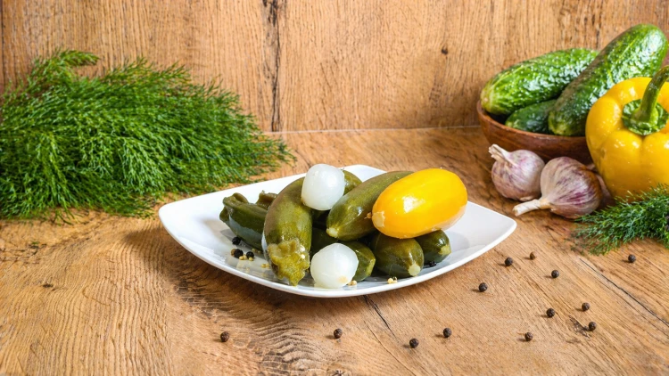 Hungarian mini zucchini pickled in vinegar with onion, mustard, coriander, and spices.